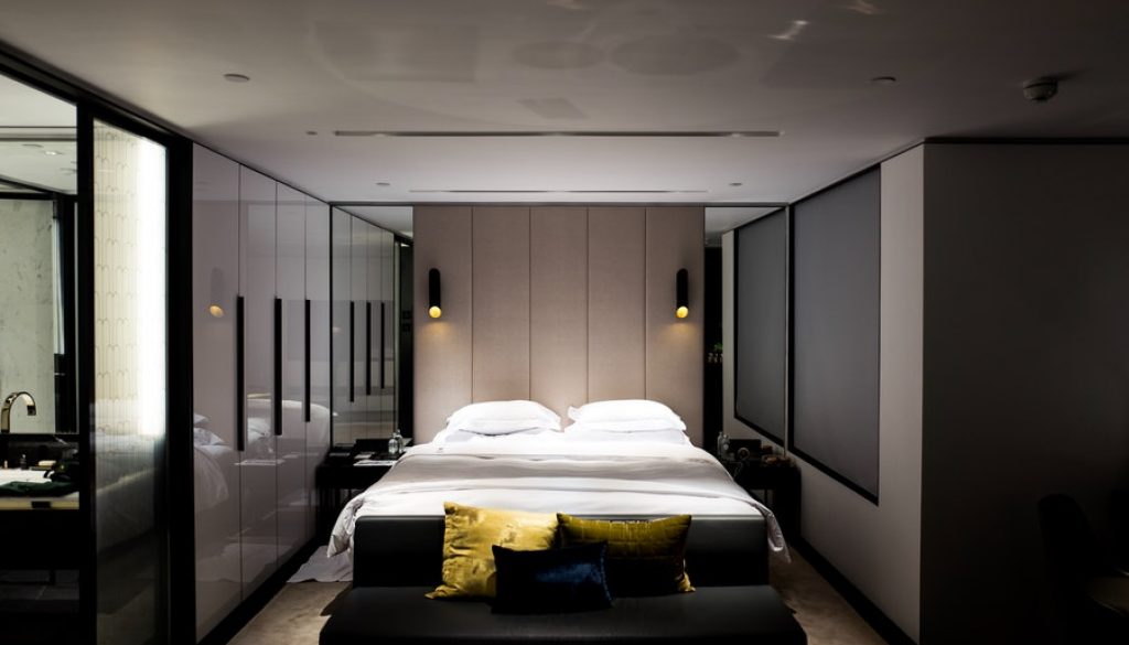 Interior design of a bedroom featuring a cozy bed and a functional desk, created by Woodmax