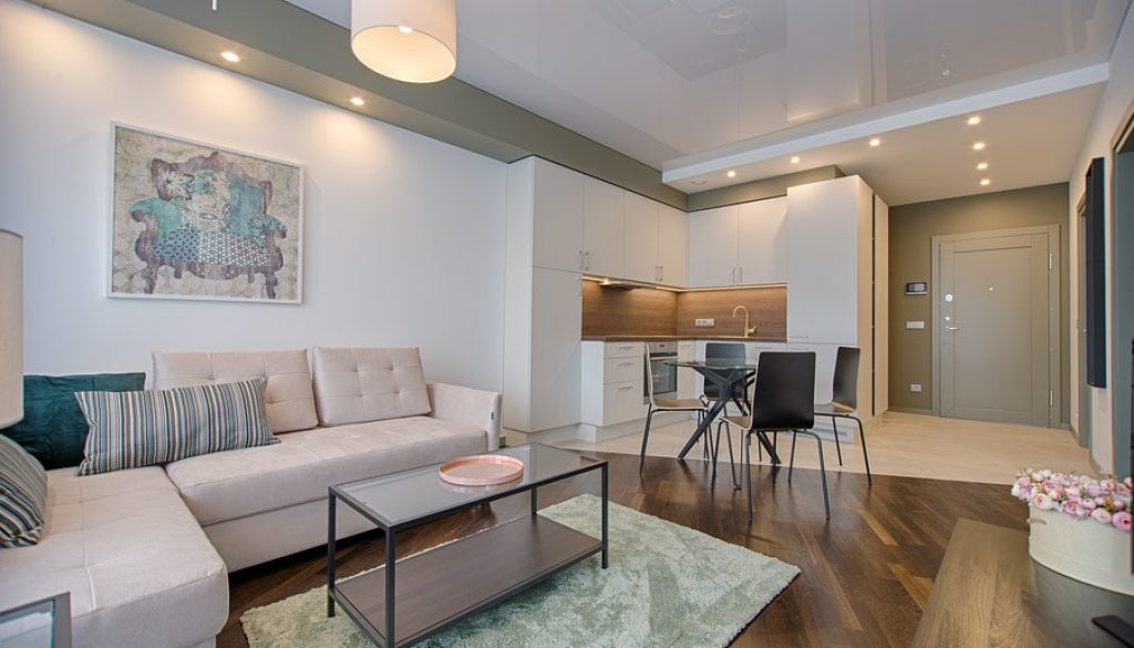 Cozy and Chic Living Room with Cushion Sofa, Round Table, and Chairs - Expertly Designed by Interior Designers in Mangalore