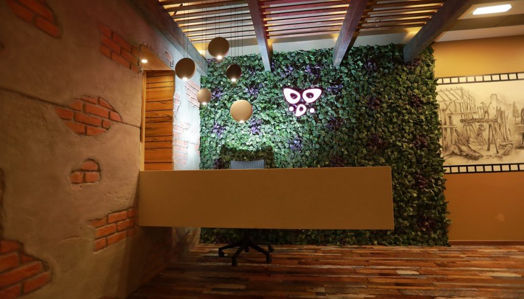 Interior design by Woodmax Interiors - A beautiful room with a large vase of flowers, created by expert interior designers in Mangalore