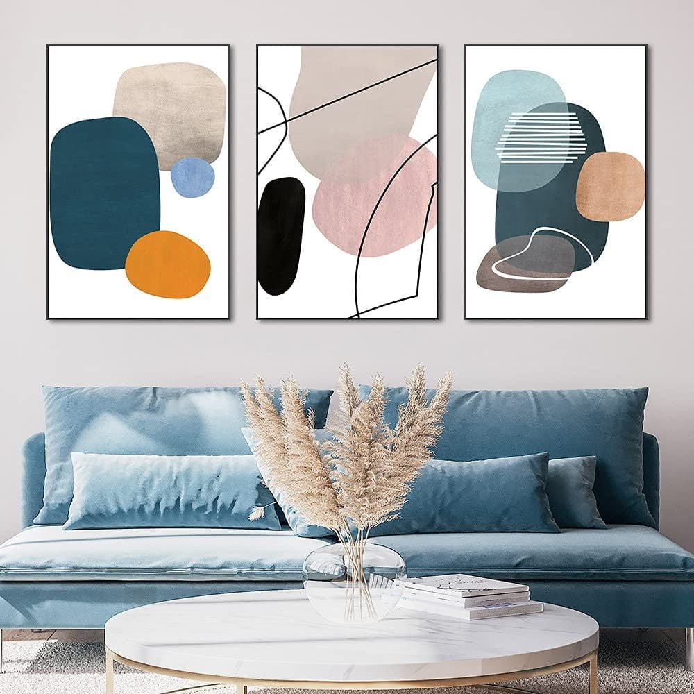 Three framed abstract canvas paintings featuring simple and modern designs, ideal for enhancing home decor. The paintings are in varying sizes and are displayed together on a wall.