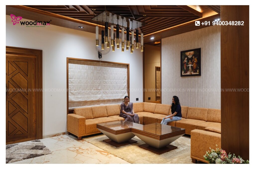 Two women relaxing on a cozy couch in a living room with a coffee table and a large window, designed by Woodmax interiors.